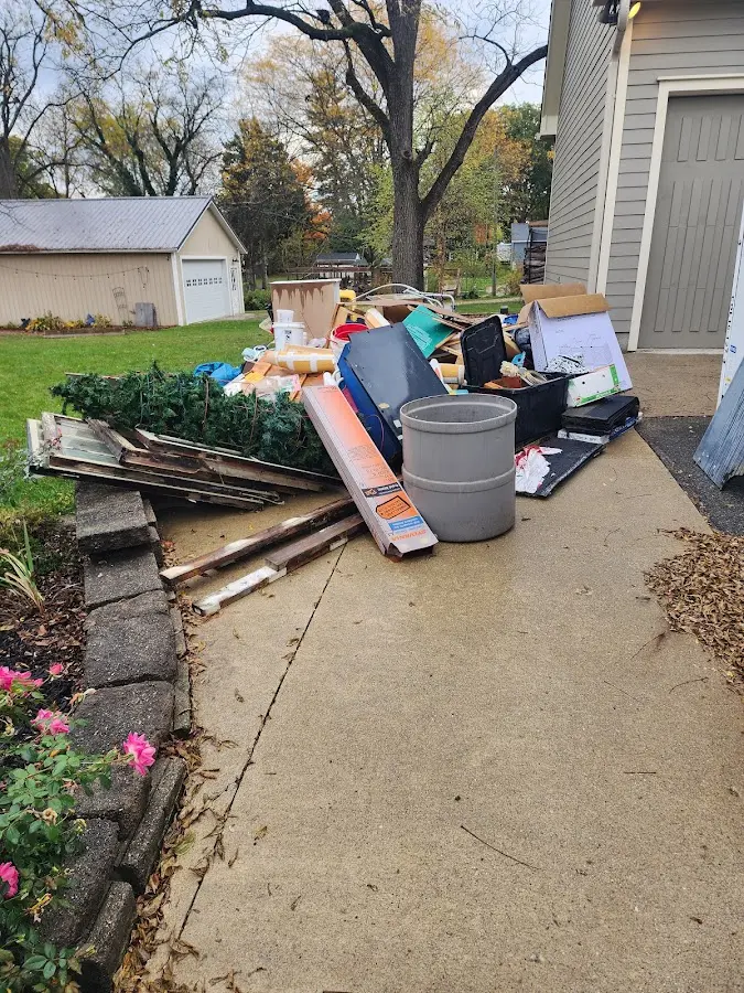 Dumpster being loaded with debris for Estate Cleanout Dumpster Rental in Henderson